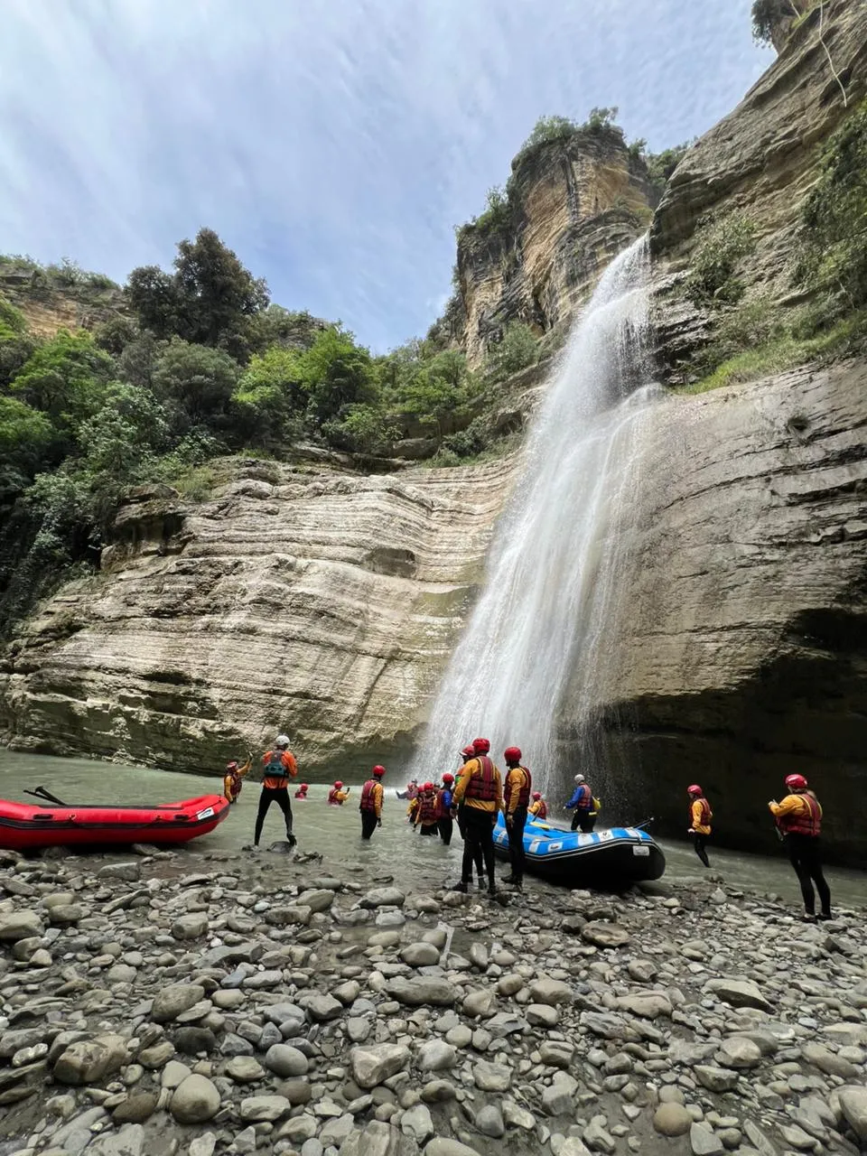 Emerald waters flowing between towering cliffs of Osum Canyon