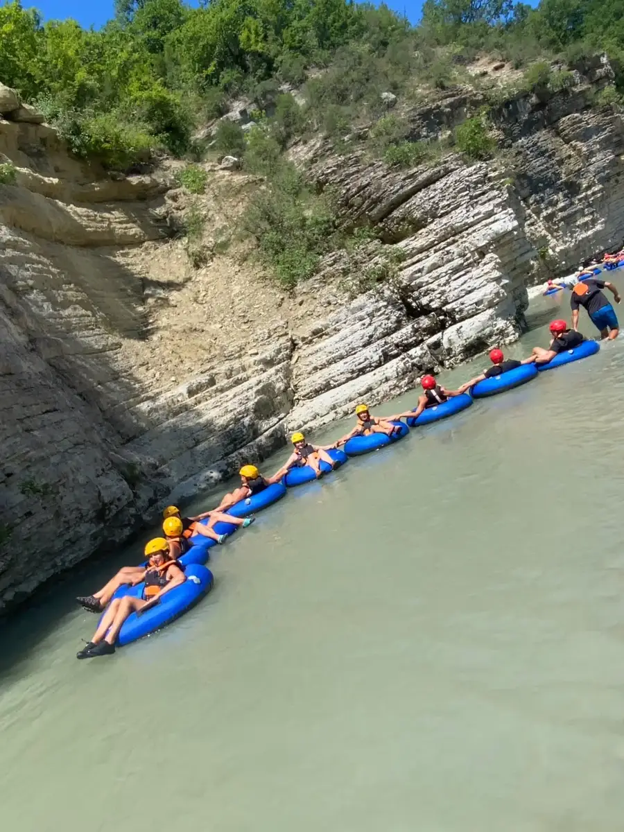 Guests floating in a chain of tubes down the Osum River in Osum Canyon
